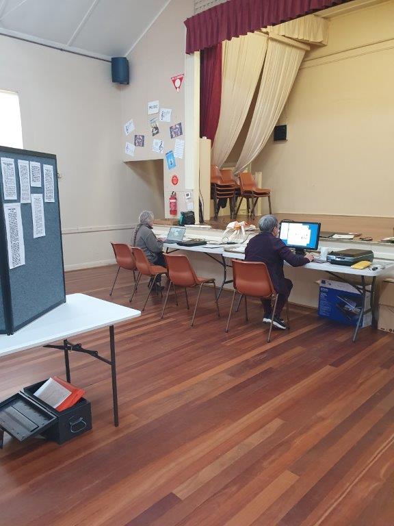 tables with computers and scanners in a large hall