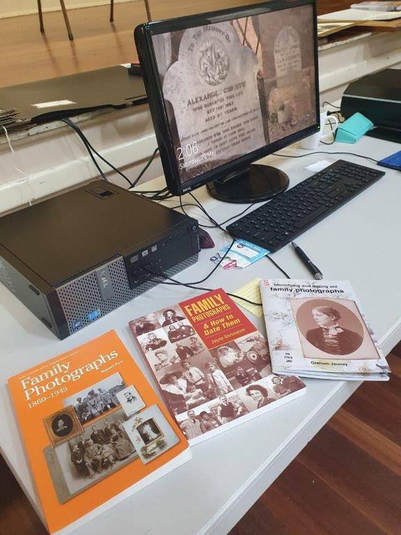 computer screen and family history books